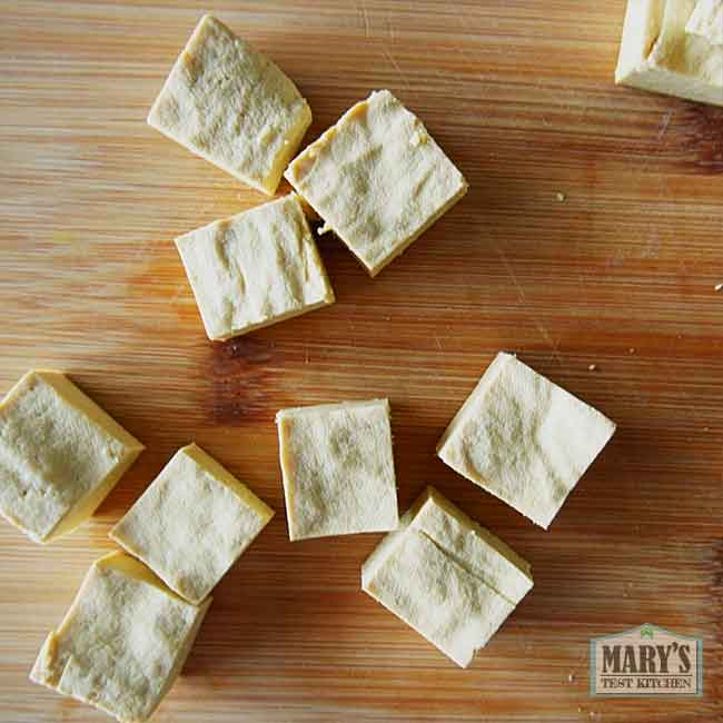 cubes of high protein chickpea tofu on cutting board