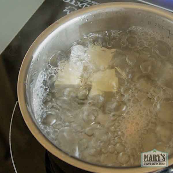 cubes of homemade pigeon tofu in boiling water