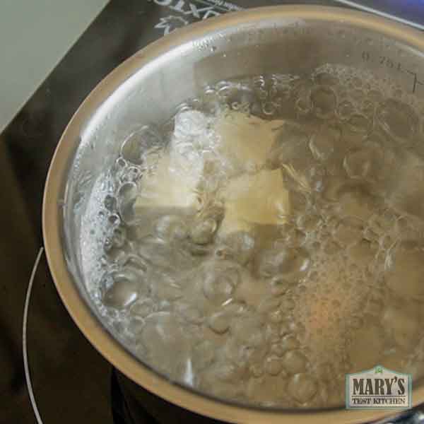 cubes of homemade pigeon pea tofu in boiling water