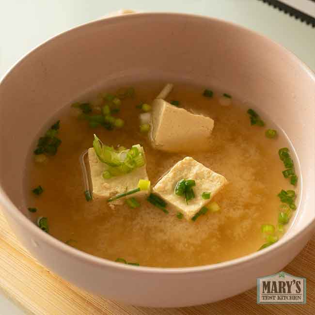 close up of boiled chickpea tofu in miso soup