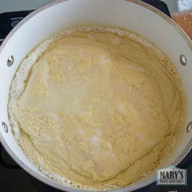 bubbling pot of chickpea milk which is curdling