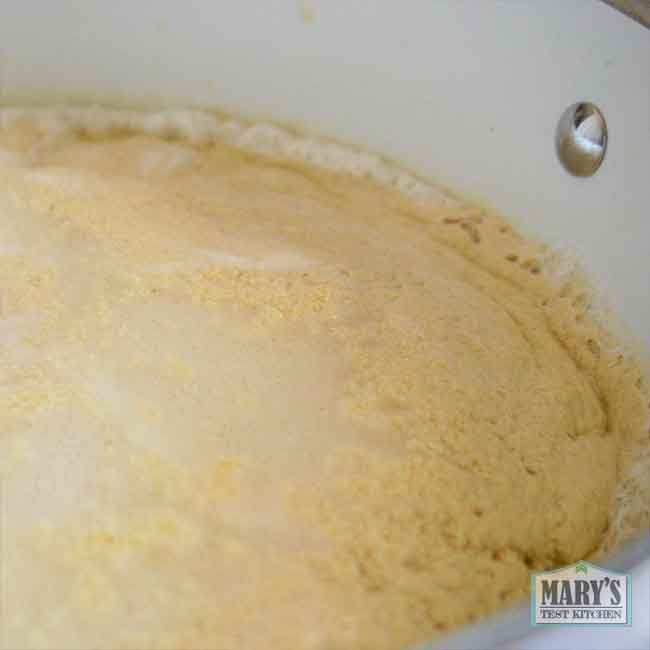 bubbling pot of chickpea milk which is curdling