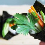 close up of vegan sushi temaki with cilantro, carrots, avocado and cucumber
