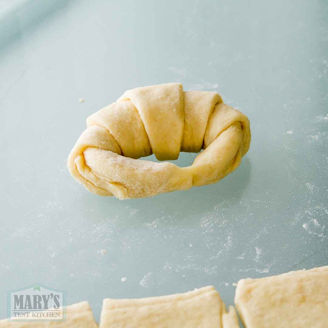 easy vegan croissant dough shaped into a crescent