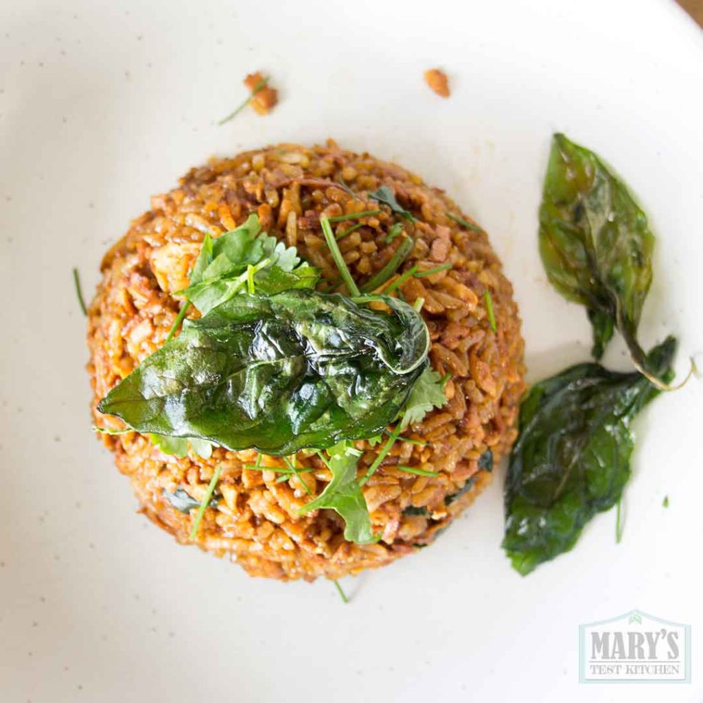 plate of san bei tofu rice with crispy thai basil garnish
