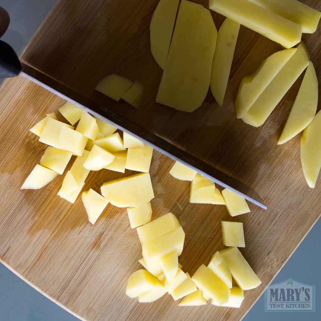 chopping potatoes for tempeh